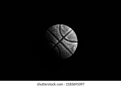 Basketball floating through the air. Basket ball isolated against a black background. Basketball swooshing through the air with a dark background. Rustic vintage aged and weathered.