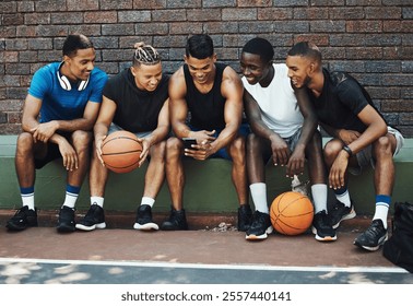 Basketball friends, rest together with phone and relax watch a funny video on smartphone after training on sports court. Healthy men, relax and tired on bench after workout game for fitness exercise - Powered by Shutterstock