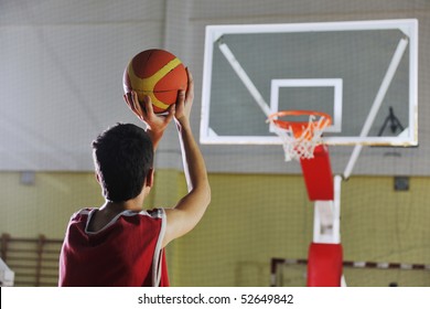 Basketball Game Playeer Shooting On Basket Indoor In Gym