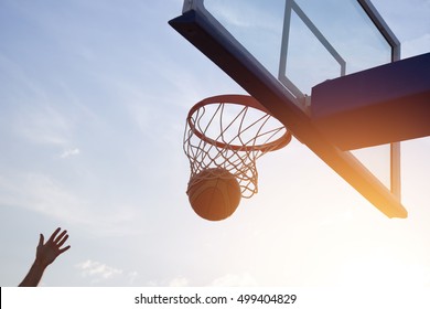 Basketball going through the basket - Powered by Shutterstock