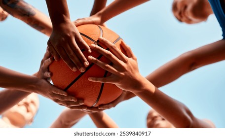 Basketball, hands together and players with ball for fitness, support or motivation in outdoor activity. Sports game, huddle and group of people in low angle for teamwork, exercise or training match - Powered by Shutterstock