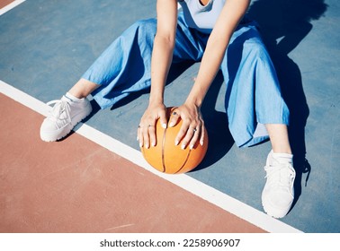 Basketball, hands and woman on the outdoor court floor with urban fashion for influencer beauty. Sport, model and young person sitting with gen z clothes with sports game equipment in summer - Powered by Shutterstock