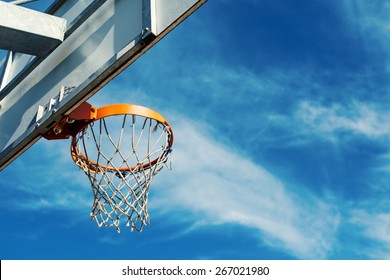 Basketball hoop against blue cloudy sky with copy space. - Powered by Shutterstock