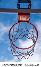 Basketball hoop and backboard as seen from below