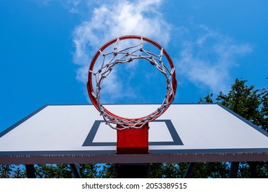 Basketball hoop and backboard viewed from the ground