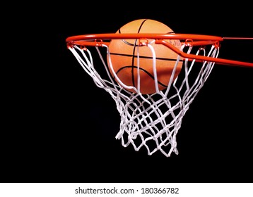 Basketball In Hoop On Black Background