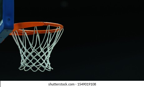 Basketball hoop on a dark background in a sports complex - Powered by Shutterstock