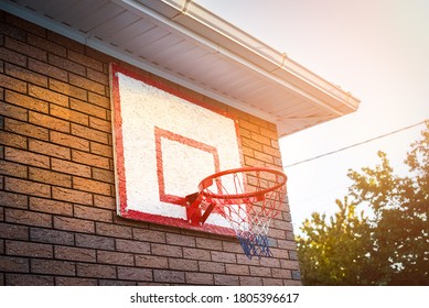 basketball hoop on the house. sunset, sunlight. outdoor sports. healthy lifestyle. Brick wall lifestyle - Powered by Shutterstock