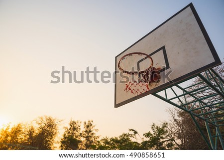 Basketball hoop in the park in the evening
