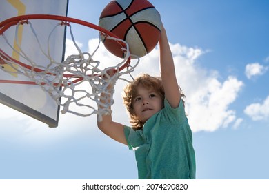 Basketball Kid Player Dunking The Ball. Child Basketball Player Making Slam Dunk.