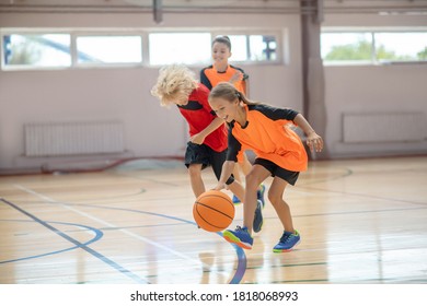 Basketball. Kids In Bright Sportswear Playing Basketball In The Gym