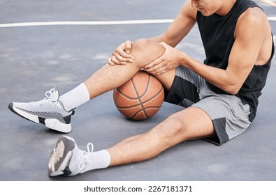 Basketball, man and knee in sports injury on the court holding painful, sore or tender area in the outdoors. Basketball player suffering from leg pain, joint or inflammation in sport match or game - Shutterstock ID 2267181371