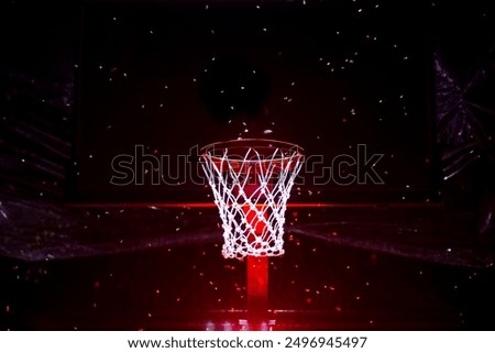 basketball net surrounded by moths at night. photo of basketball net noise at night