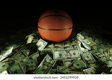 Basketball on a pile of cash -- money and betting in sports concept 