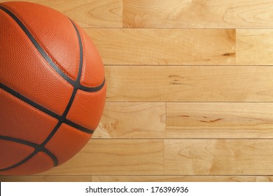 A Basketball On A Wood Gym Floor Viewed From Above