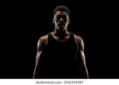 Basketball player against black background. Serious concentrated african american man silhouette. - Powered by Shutterstock