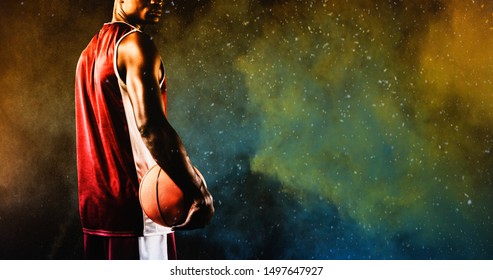 Basketball player against splashing of yellow color powder - Powered by Shutterstock