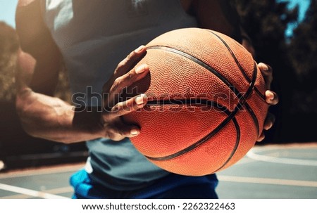 Basketball, basketball player and athlete hands closeup holding ball on basketball court in urban city park outside. African man, sports fitness and healthy lifestyle wellness training outdoors