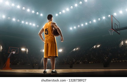 Basketball Player With A Ball On Basketball Court. Back View