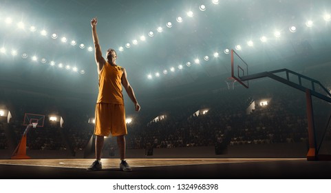 Basketball player celebrates victory on a floodlit professional basketball court - Powered by Shutterstock