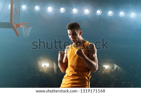 Basketball player celebrates victory on a professional sports arena