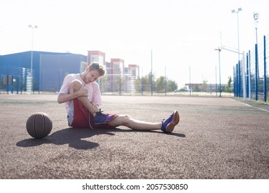 Basketball Player Having An Injury, Lying On The Court And Feeling Pain