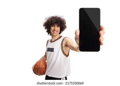 Basketball player holding a ball and showing a smartphone isolated on white background - Powered by Shutterstock