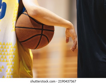 Basketball player holding game ball. Basketball training session. Closeup image of basketball - Powered by Shutterstock