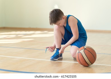 A Basketball Player Lacing Shoes