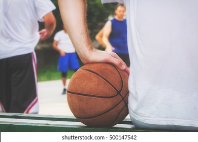 Basketball Player Making Pause On The Bench.