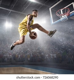 Basketball Player On Big Professional Arena During The Game. Basketball Player Makes Slam Dunk. Player Wears Unbranded Clothes.