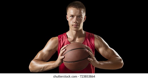 Basketball player on a black background. Isolated basketball players in unbranded clothes. Player hold a ball. - Powered by Shutterstock