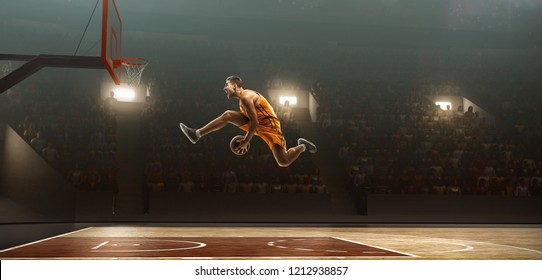 Basketball player on professional arena during the game makes slam dunk - Powered by Shutterstock