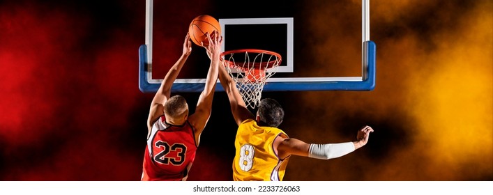 Basketball player players in action. Basketball on lightning background. Concept with copy space - Powered by Shutterstock