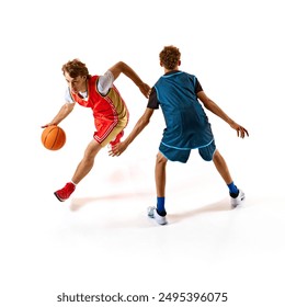 Basketball player in red jersey skillfully dribbles ball, attempting to bypass defender in blue who blocking his path against white studio background. Concept of sport, competition, match, team games. - Powered by Shutterstock