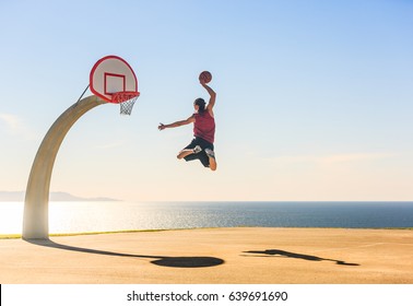 Basketball Player scoring an amazing slam dunk outdoors. - Shutterstock ID 639691690