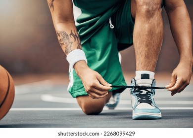 Basketball player shoes on court, start game and hands tie sneakers shoelaces with ball. Sports man prepare for competition, player training in summer and strong athlete kneeling ready for workout - Powered by Shutterstock