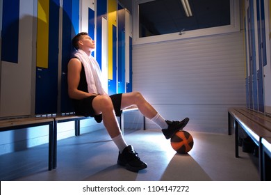 Basketball Player Sitting In The Locker Room.