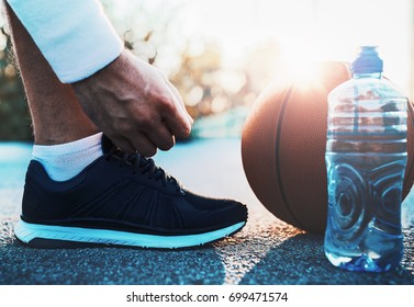 Basketball Player Tying Sport Shoes. Sport, Recreation Concept