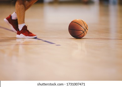 Basketball Player Walking On Wooden Court. Basketball Over The Floor. Basketball Sports Court