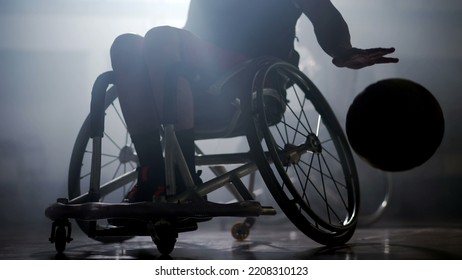  basketball player in wheelchair with dramatic lighting. Athlete with  hard backlight - Powered by Shutterstock