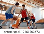 Basketball players in action during a game at indoor court. 