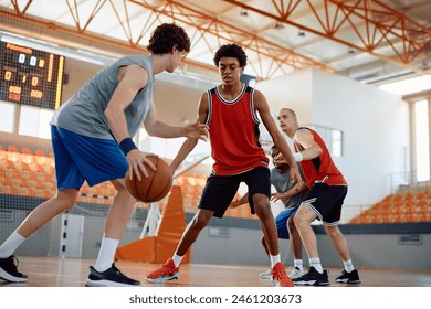 Basketball players in action during a game at indoor court.  - Powered by Shutterstock