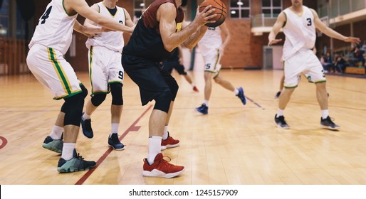 Basketball Players in Action. High School Basketball Team Playing Game - Powered by Shutterstock