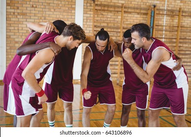 Basketball Players Forming A Huddle In The Court 