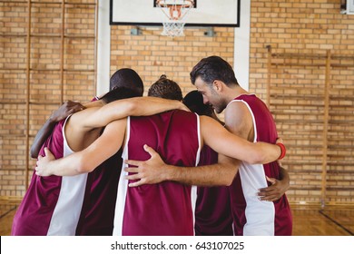 Basketball Players Forming A Huddle In The Court 