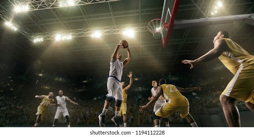 Basketball Players On Big Professional Arena During The Game. Basketball Player Makes Slum Dunk