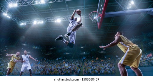 Basketball Players On Big Professional Arena During The Game. Basketball Player Makes Slam Dunk. Bottom View