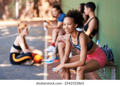 Basketball, smile and thinking with woman on bench at court for break, fitness or sports outdoor. Future, idea and vision with happy African athlete person at venue for competition or challenge - Powered by Shutterstock