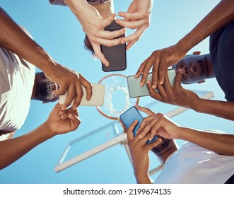 Basketball team in a circle with phone networking on social media while standing on a court. Sports group doing research on game strategy, collaboration and skill together with technology. - Powered by Shutterstock